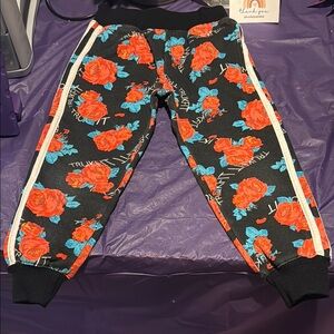 Trukfit| Floral Black and Red Sweatpants with Sporty Style
With pockets